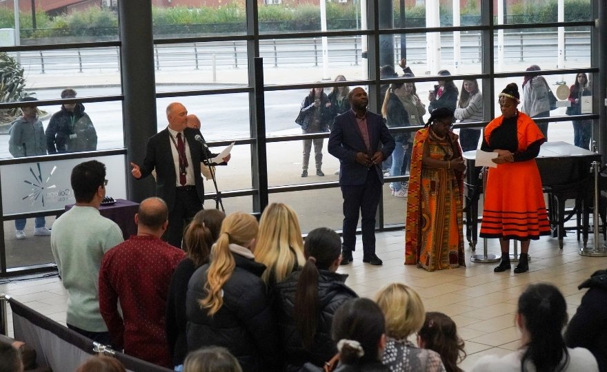 Darren Hankey (Principal, HCFE) welcomes and addresses the packed Atrium for the Opening Ceremony of Black History Month