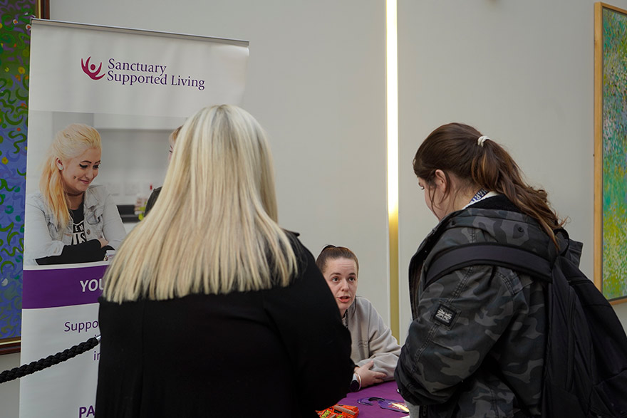 Students talking to stall holder